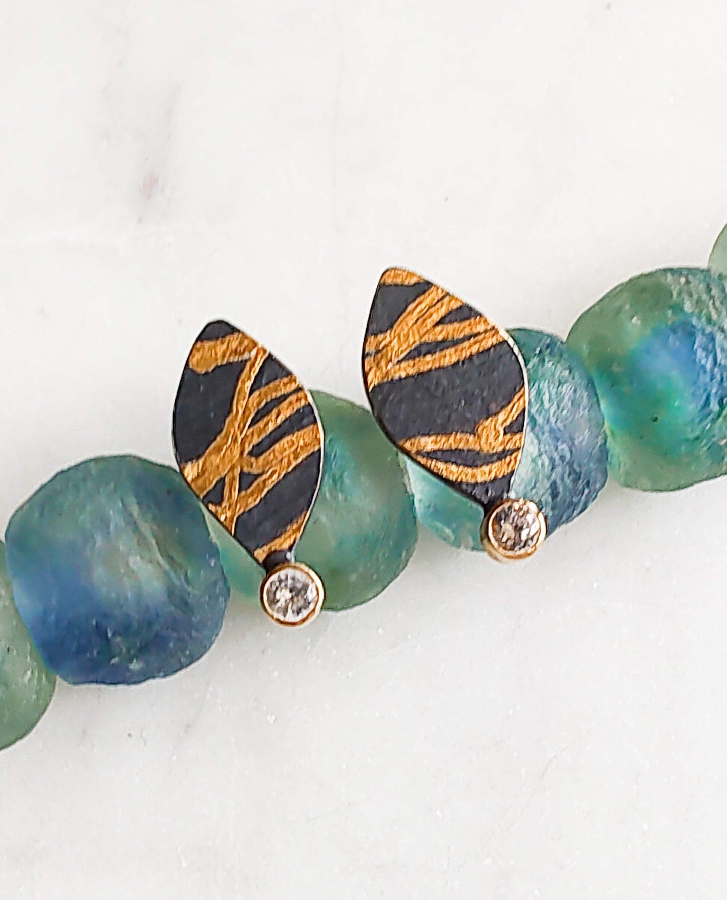 White Sapphire and Gold Ribbon Stud Earrings